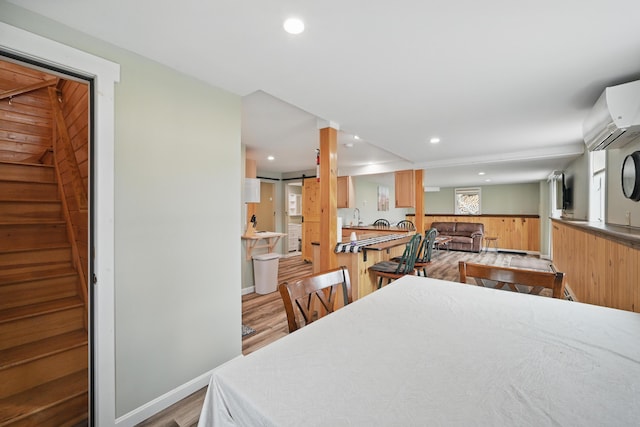 17 Kokadjo N Rd, Frenchtown Twp, ME 04441 - dining space featuring wood finished floors, stairway, wainscoting, wood walls, and recessed lighting