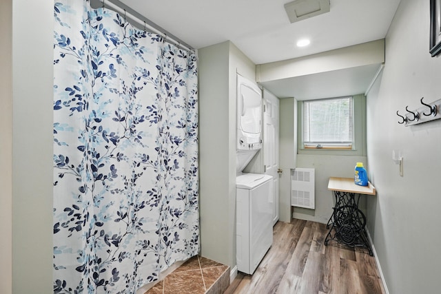17 Kokadjo N Rd, Frenchtown Twp, ME 04441 - washroom with estacked washer and dryer, radiator heating unit, wood finished floors, and attic access