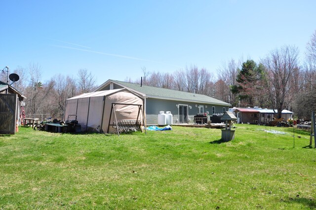 back of house with a lawn
