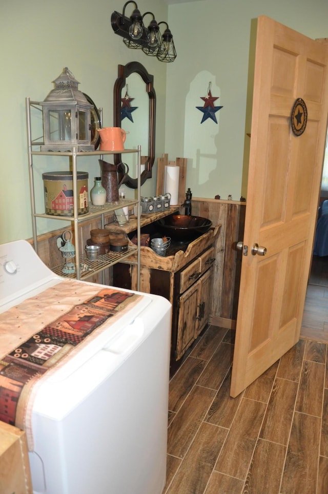 clothes washing area with laundry area and wood finish floors