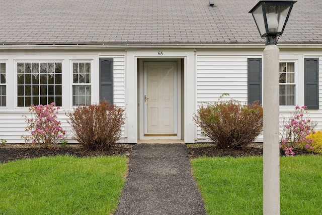66 Colonial Vlg Unit 66, Falmouth, ME 04105 - view of exterior entry featuring a yard