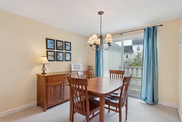 66 Colonial Vlg Unit 66, Falmouth, ME 04105 - dining room featuring light colored carpet, an inviting chandelier, and baseboards