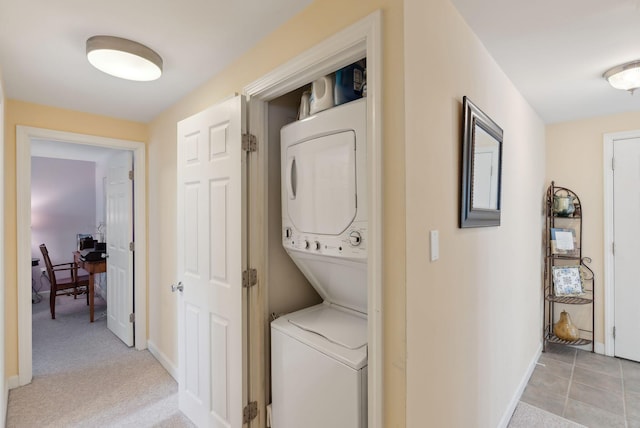 66 Colonial Vlg Unit 66, Falmouth, ME 04105 - clothes washing area with baseboards, laundry area, and stacked washer / drying machine