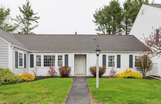 66 Colonial Vlg Unit 66, Falmouth, ME 04105 - view of front of home with a front yard and a shingled roof