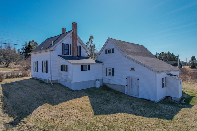 1357 Indian River Rd, Addison, ME 04606 - back of house featuring a chimney, a yard, and a shingled roof