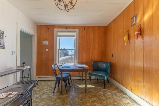 1357 Indian River Rd, Addison, ME 04606 - dining area with wooden walls, a baseboard heating unit, and a chandelier