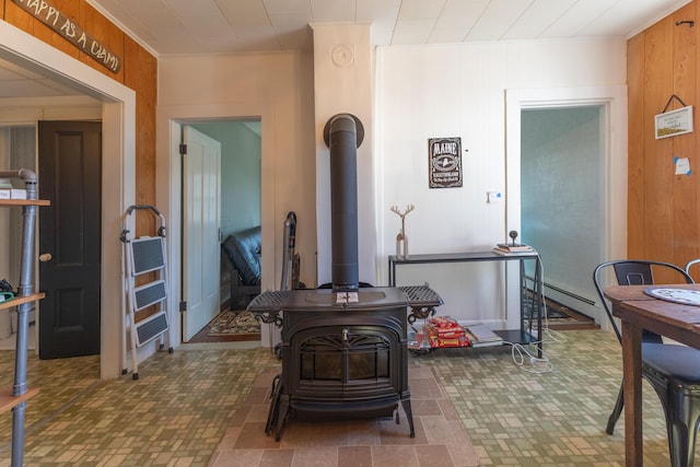 1357 Indian River Rd, Addison, ME 04606 - office space with a wood stove, brick patterned floors, baseboard heating, and wooden walls