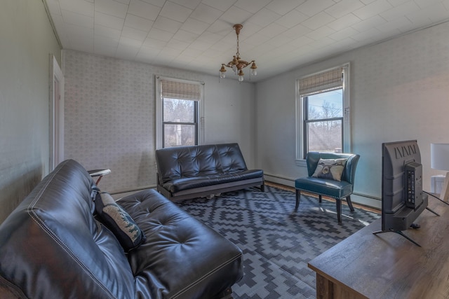 1357 Indian River Rd, Addison, ME 04606 - living room featuring a baseboard radiator and a chandelier