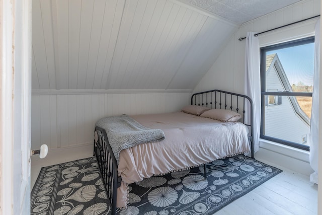 1357 Indian River Rd, Addison, ME 04606 - bedroom featuring vaulted ceiling, wood finished floors, and wooden walls