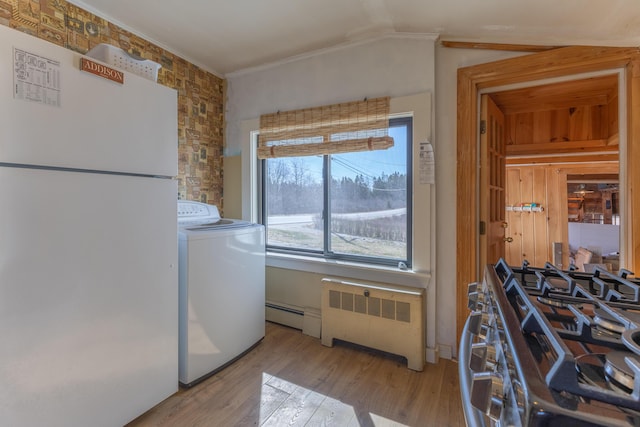 1357 Indian River Rd, Addison, ME 04606 - washroom with washer / dryer, radiator, ornamental molding, light wood finished floors, and a baseboard heating unit