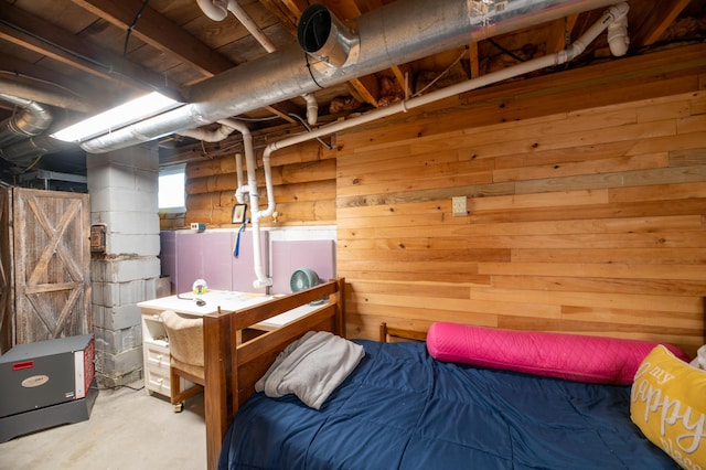 114 Smith Rd, Hudson, ME 04449 - bedroom with wood walls and unfinished concrete flooring