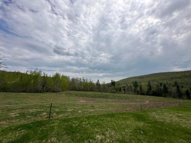 153 Spaulding Lake Rd, Oakfield, ME 04763 - view of yard with fence, a rural view, and a forest view