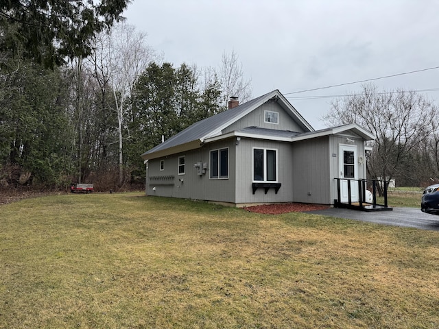 3043 W Chapman Rd, Mapleton, ME 04757 - view of side of property featuring a lawn and a chimney