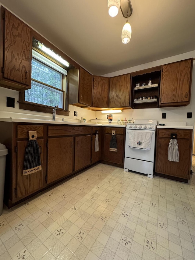 3043 W Chapman Rd, Mapleton, ME 04757 - kitchen featuring open shelves, electric range, dark brown cabinets, light floors, and light countertops