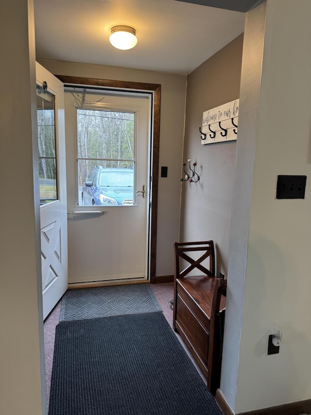 3043 W Chapman Rd, Mapleton, ME 04757 - doorway to outside featuring baseboards and carpet flooring