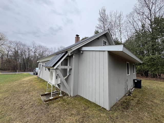 3043 W Chapman Rd, Mapleton, ME 04757 - view of side of property with a lawn and a chimney