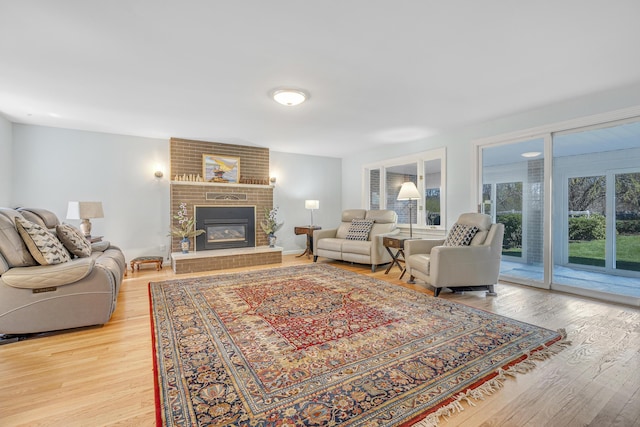 living area with light wood-style floors and a fireplace