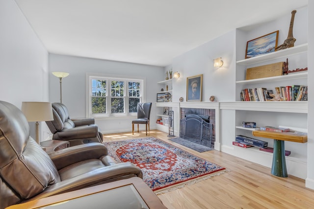 living room featuring wood finished floors and a fireplace