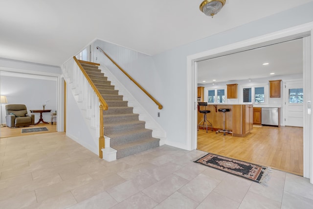 entryway featuring baseboards, stairs, recessed lighting, and light tile patterned flooring
