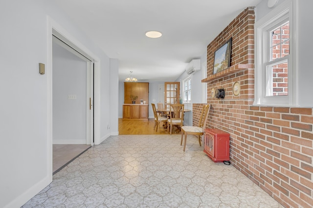 hall with a wall mounted AC and baseboards