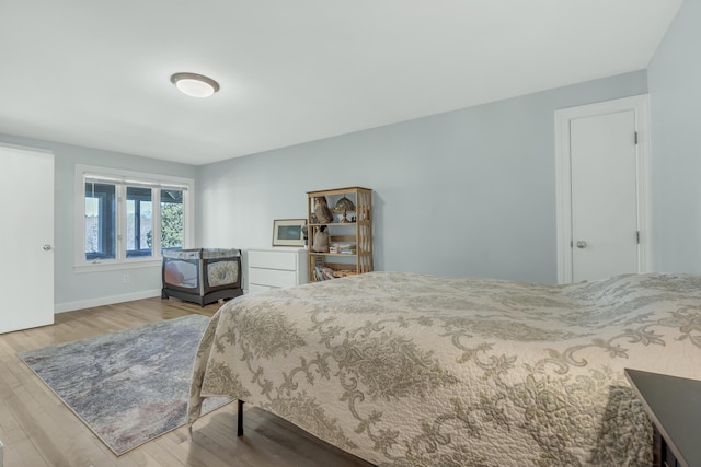 bedroom featuring wood finished floors and baseboards