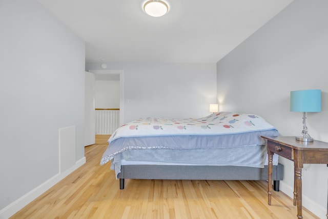bedroom featuring baseboards and wood finished floors