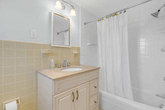 bathroom featuring vanity, tile walls, and shower / tub combo