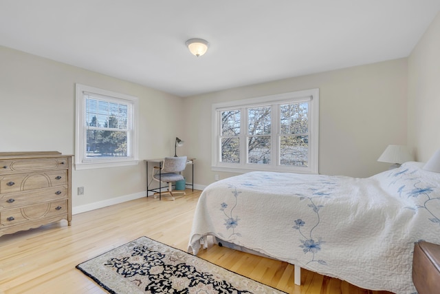 bedroom with baseboards and wood finished floors