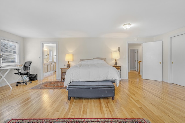 bedroom featuring light wood-type flooring and baseboards