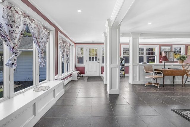 entrance foyer with ornamental molding, dark tile patterned flooring, recessed lighting, and decorative columns