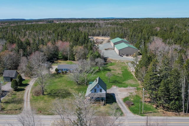 birds eye view of property featuring a view of trees