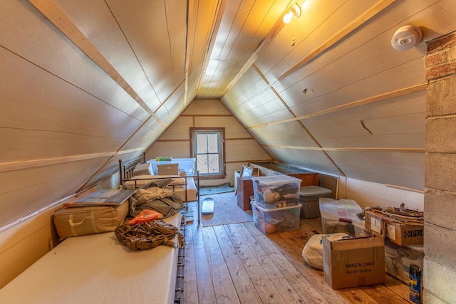 bonus room with wood ceiling, wood-type flooring, vaulted ceiling, and wood walls
