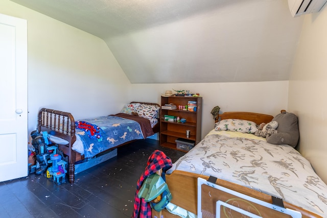 bedroom featuring wood finished floors, lofted ceiling, and a wall mounted air conditioner