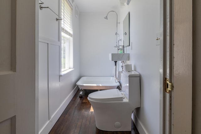 bathroom featuring crown molding, toilet, baseboards, and hardwood / wood-style flooring
