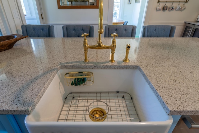 interior details featuring a sink and stone counters