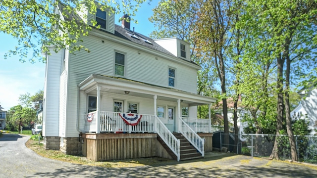 25 Nevens St Unit 1, Portland, ME 04103 - view of front facade featuring covered porch, fence, stairs, a chimney, and driveway