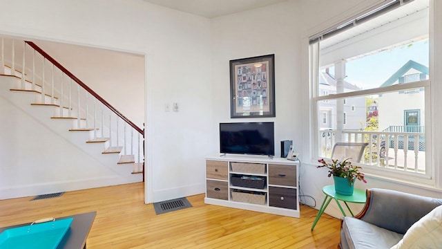 25 Nevens St Unit 1, Portland, ME 04103 - living area featuring hardwood / wood-style flooring, stairway, plenty of natural light, and baseboards
