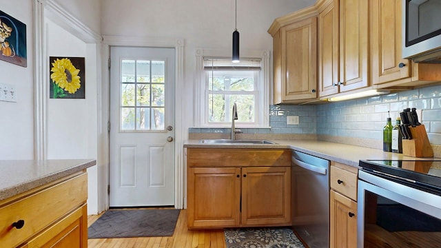 25 Nevens St Unit 1, Portland, ME 04103 - kitchen featuring a sink, stainless steel appliances, light countertops, and backsplash