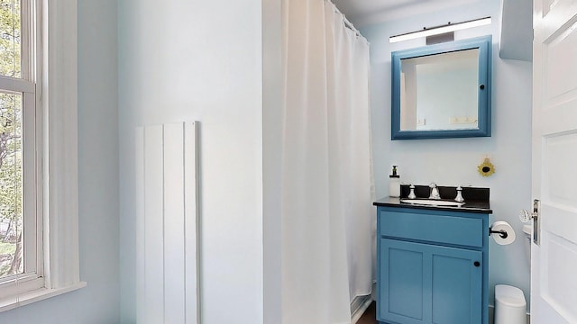 25 Nevens St Unit 1, Portland, ME 04103 - bathroom featuring vanity, radiator heating unit, and a shower with shower curtain