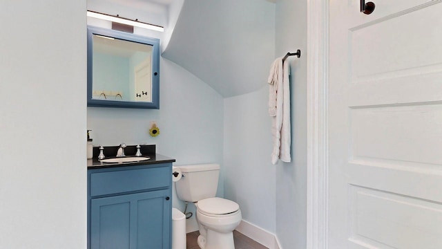 25 Nevens St Unit 1, Portland, ME 04103 - half bathroom with vanity, toilet, lofted ceiling, and baseboards