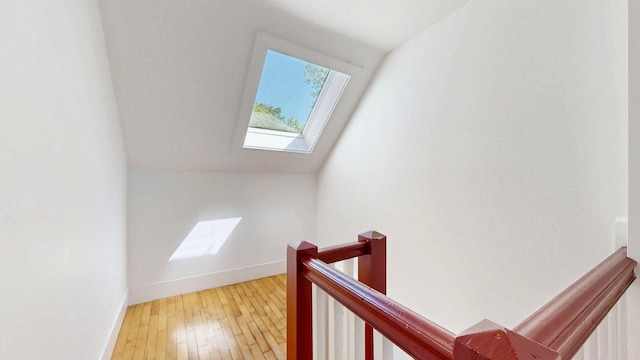 25 Nevens St Unit 1, Portland, ME 04103 - stairs with a skylight, baseboards, and hardwood / wood-style flooring