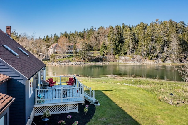 dock area with a lawn and a deck with water view