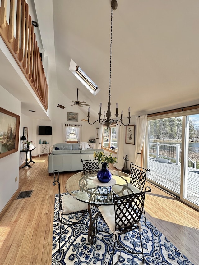 dining room with visible vents, light wood-style floors, and plenty of natural light