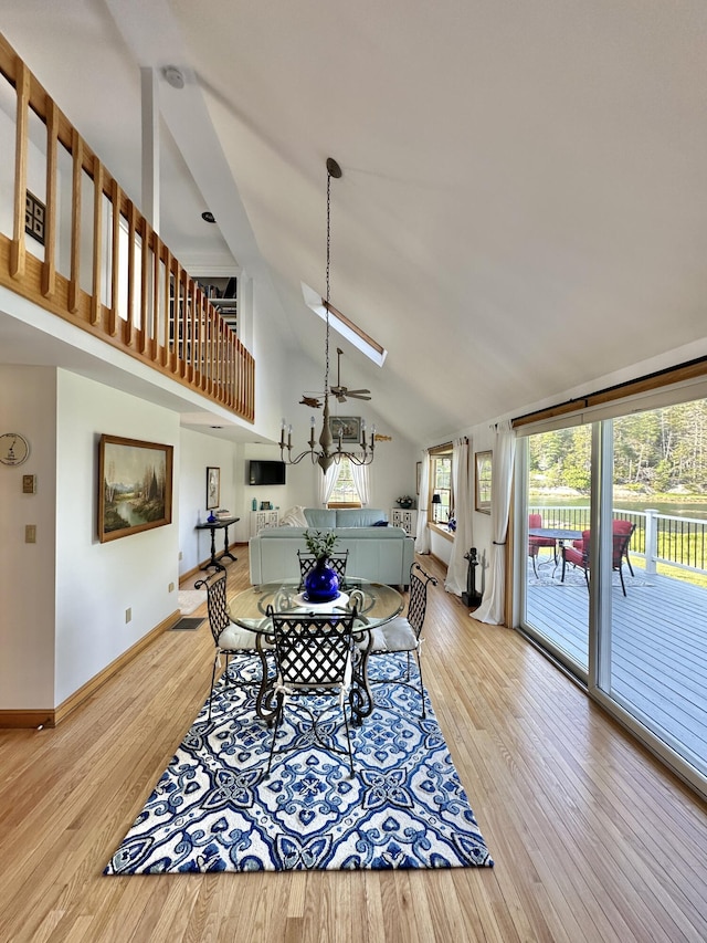 156 Scraggle Point Rd, Saint George, ME 04859 - dining space with high vaulted ceiling, light wood finished floors, a ceiling fan, and a skylight