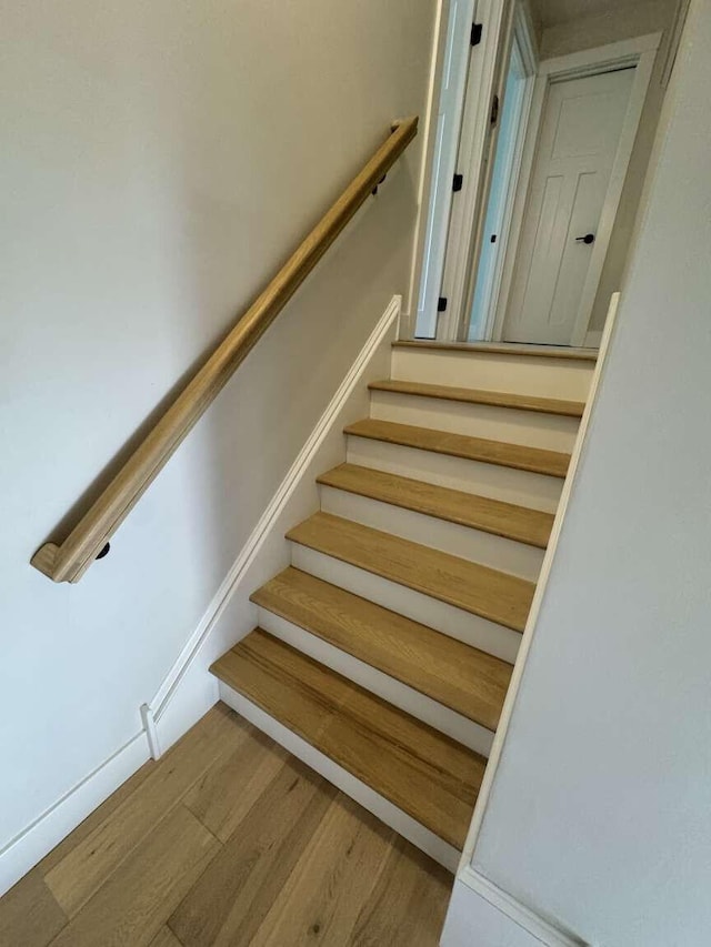 stairway with wood finished floors