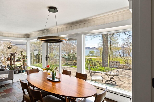 69 Brookside Rd, Portland, ME 04103 - dining area with a baseboard radiator, a water view, and dark stone finish floors