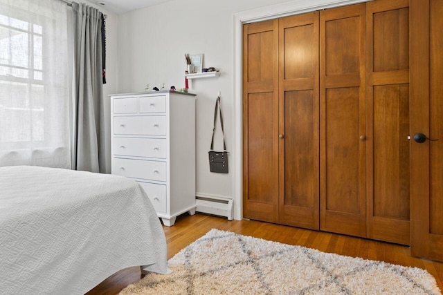69 Brookside Rd, Portland, ME 04103 - bedroom with baseboard heating, light wood-type flooring, and multiple windows