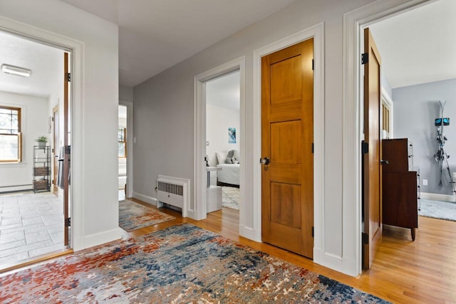 69 Brookside Rd, Portland, ME 04103 - hall with radiator, wood finished floors, baseboards, and a baseboard radiator