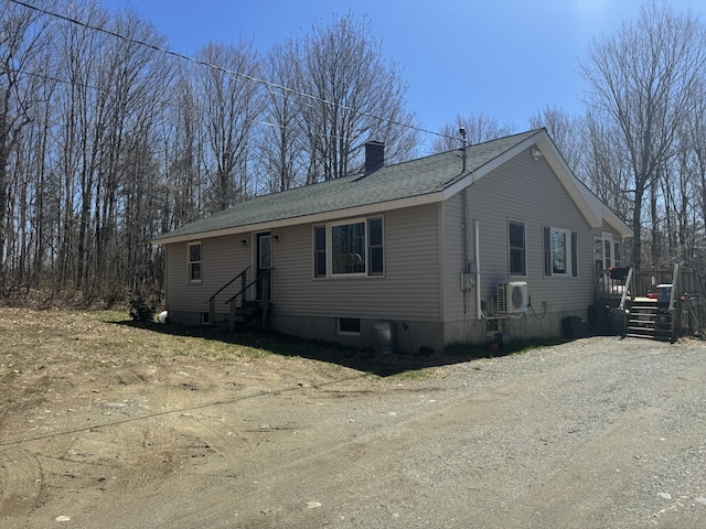 76 Norton Hill Rd, Dover-Foxcroft, ME 04426 - manufactured / mobile home with a deck, a chimney, a shingled roof, entry steps, and ac unit