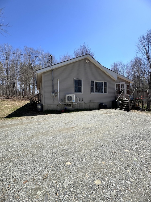 76 Norton Hill Rd, Dover-Foxcroft, ME 04426 - exterior space with a deck, ac unit, and gravel driveway